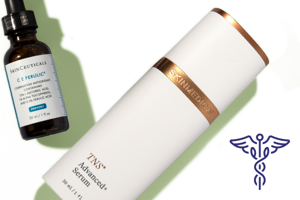 SkinCeuticals C E Ferulic vitamin C serum and TNS Advanced+ Serum on green background