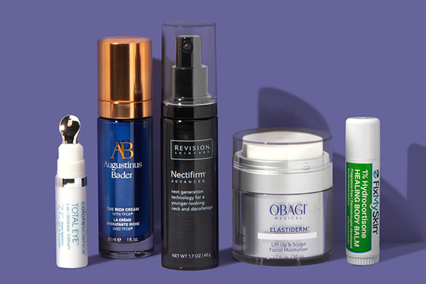 Collection of skin care products including Obagi Elastiderm, Revision Skincare Nectifirm, Augustinus Bader The Rich Cream, MDRX3 and Fix My Skin Healing Lip Balm on purple background