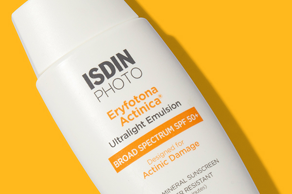 ISDIN Photo Eryfotona Actinica Ultralight Emulsion Broad Spectrum SPF 50+ sunscreen on yellow background
