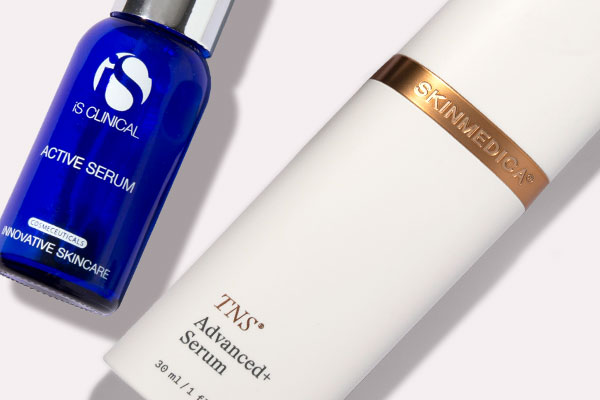 iS Clinical Active Serum and Skin Medica TNS Advanced Serum Skin Care products on off-white background